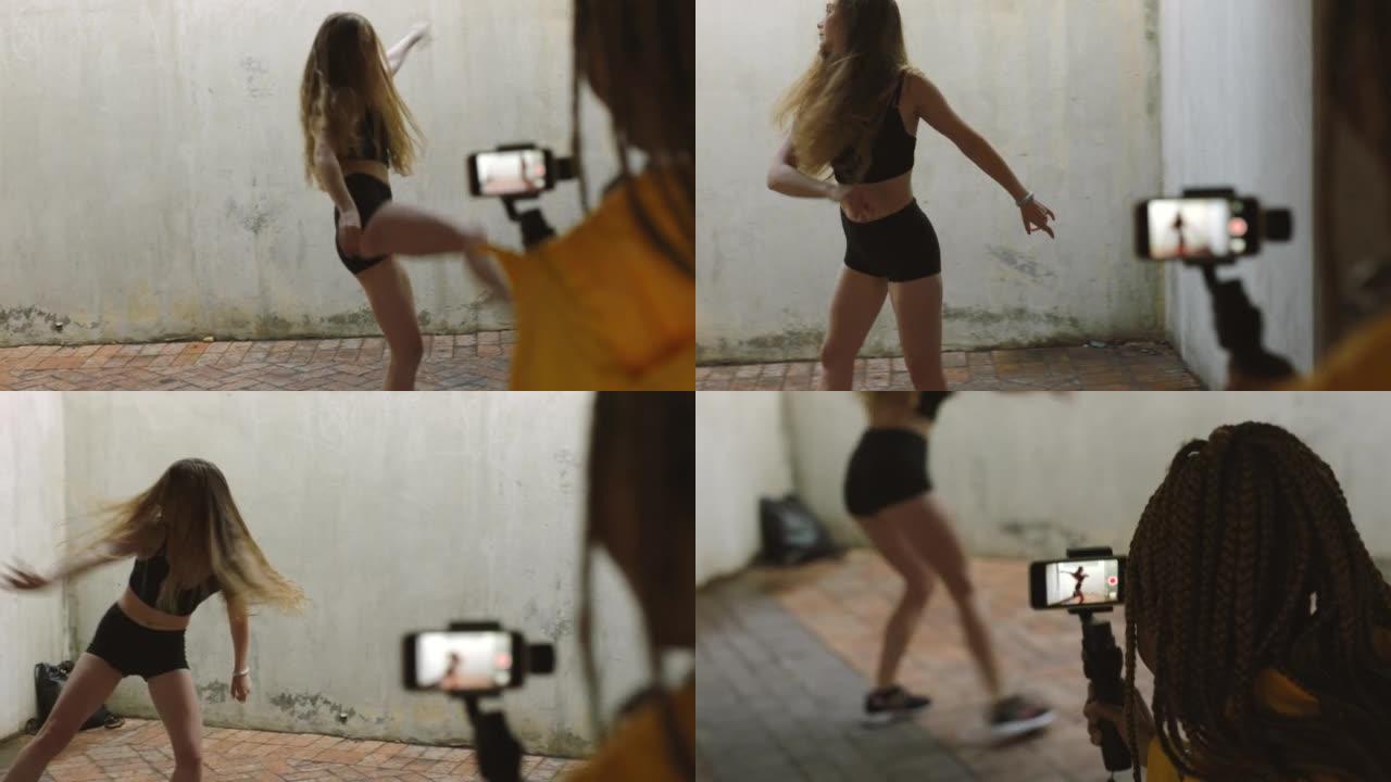 影响者跳舞，在垃圾美学中通过智能手机视频制作社交媒体内容。具有健康，健身和活力的实时流媒体摄像师女性