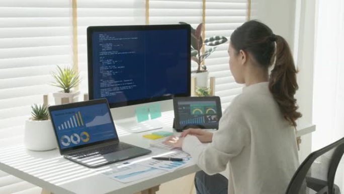 亚洲年轻女性的后视图，自由数据科学家在家庭远程工作编码程序，从事大数据挖掘，人工智能数据工程，it技