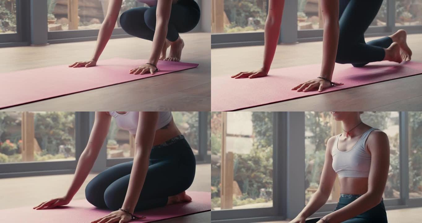 4k视频片段，一名年轻女子在准备瑜伽程序时推出运动垫