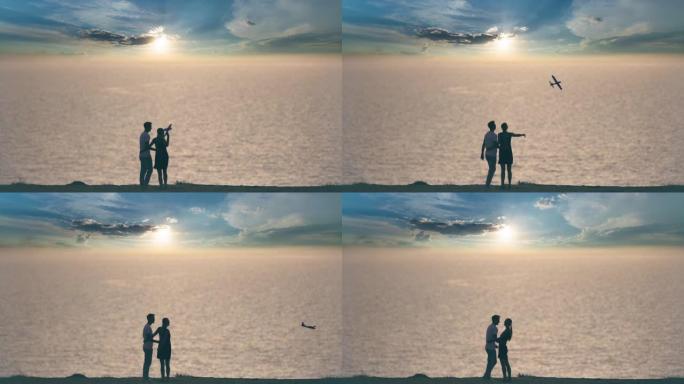 男人和女人把玩具飞机扔在海景背景上。慢动作