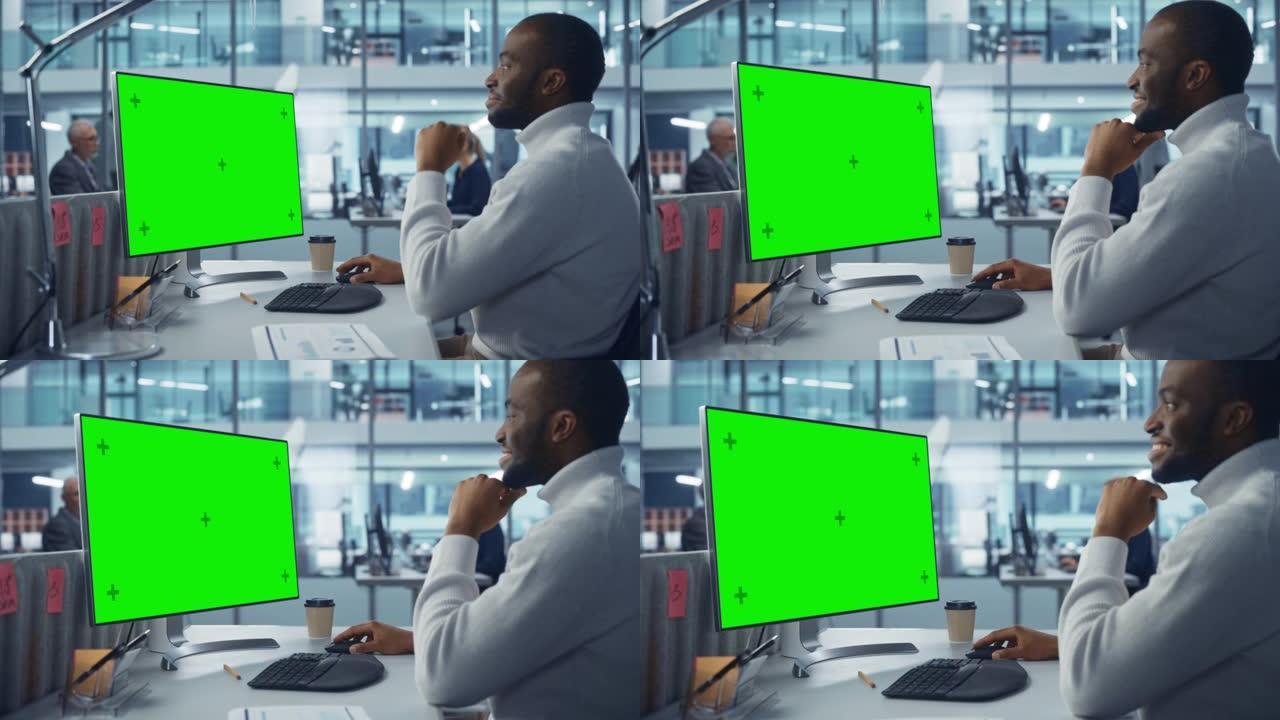 多样化的现代办公室: 英俊的黑色信息技术人员使用带有绿色色度键屏幕的台式计算机。工程师管理员从事电子