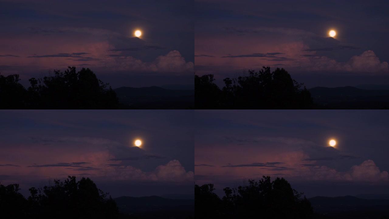 戏剧性的傍晚天空，满月和暴风云在乡村上空滚动