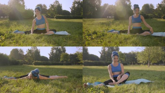 迷人的年轻女子，蓝色的头发，穿着蓝色的瑜伽服，在公园的草地上做瑜伽，在美丽的阳光下左右伸展到直腿，一