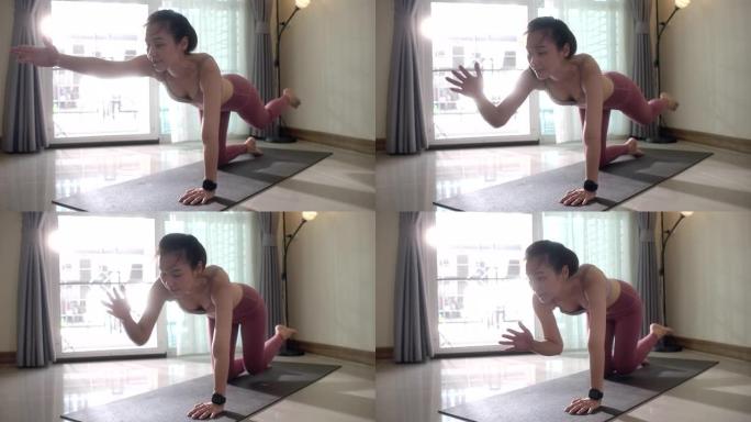 亚洲女性在家练习瑜伽运动