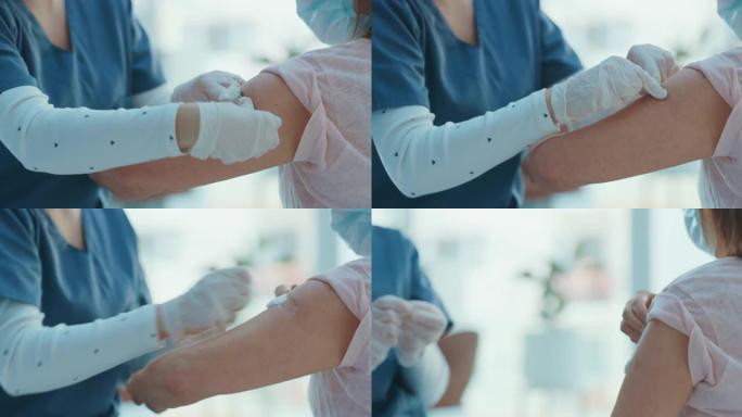 4k视频片段，一名无法辨认的护士在给她的病人注射了Covid疫苗后给她贴了创可贴