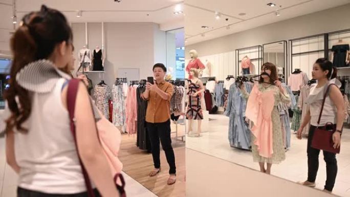 亚洲华人女性在服装店选择衣服