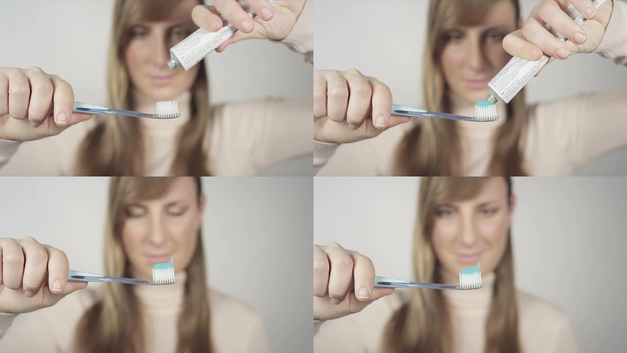 女性将牙膏挤到牙刷上