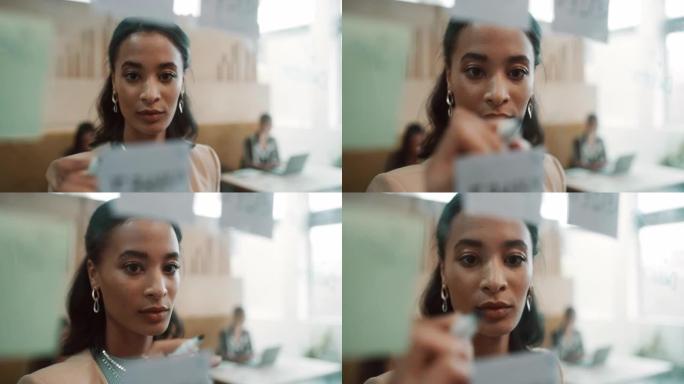 4k视频片段，一位迷人的年轻女商人站在办公室并在集思广益时使用视觉辅助工具