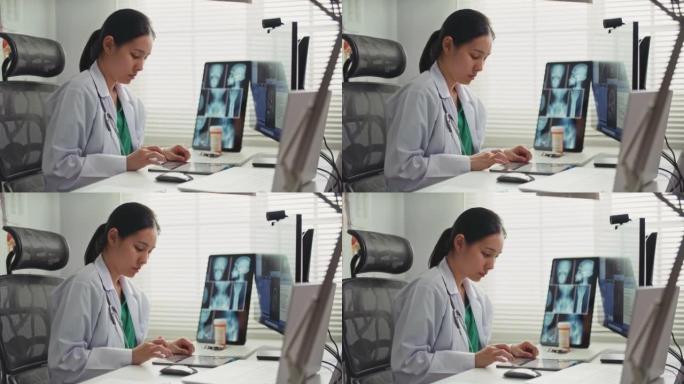 医生在诊所用数字平板电脑为病人写处方
