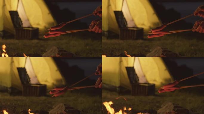 篝火上的油炸香肠野炊烤肠野营