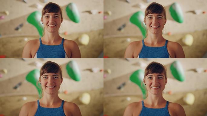 适合美丽的女运动员在抱石墙背景的攀岩馆微笑和摆姿势。迷人自信快乐的黑发女人做运动。健康的生活方式肖像