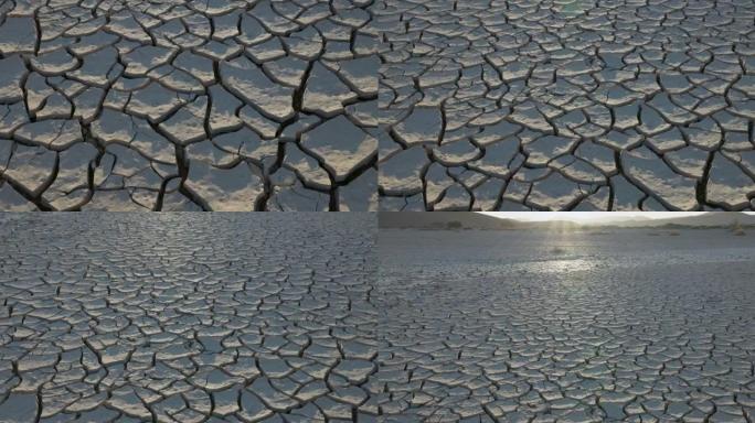 气候变化。由于气候变化和全球变暖造成的干旱，干旱大坝的图案化开裂的泥浆表面的特写视图