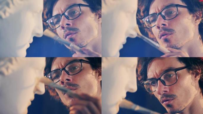 在给半身像除尘时关闭雕塑家的脸。设计、创意、灵感概念。