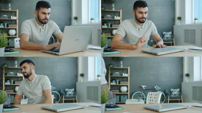 疲惫的自由职业者阿拉伯男子在公寓里用笔记本电脑工作，然后辞职