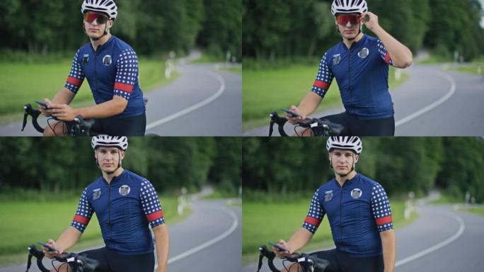 一位年轻的公路自行车手的SLO MO肖像在路边使用他的智能手机