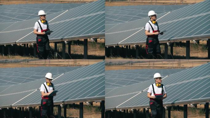 男技术员正在检查太阳能电池板。太阳能工厂附近的替代能源工人。