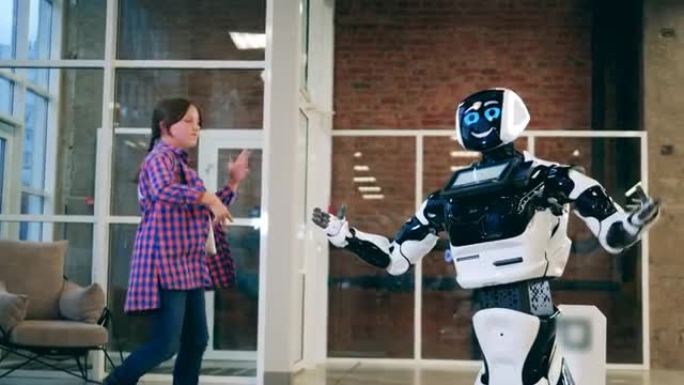 一个女孩在半机械人附近跳跃和跳舞。人工智能、机器人创新、机器人概念。