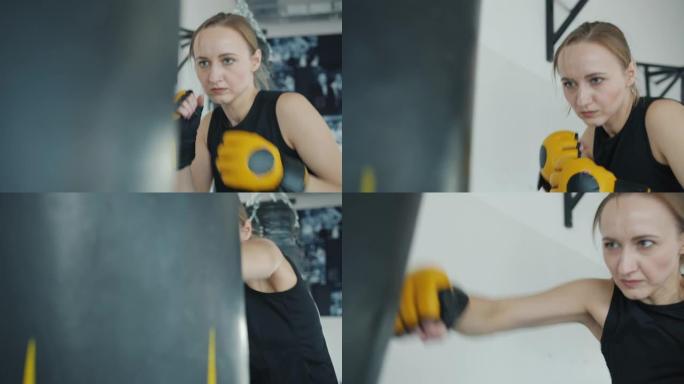强大的女跆拳道训练，在室内用沙袋在健身房单独锻炼
