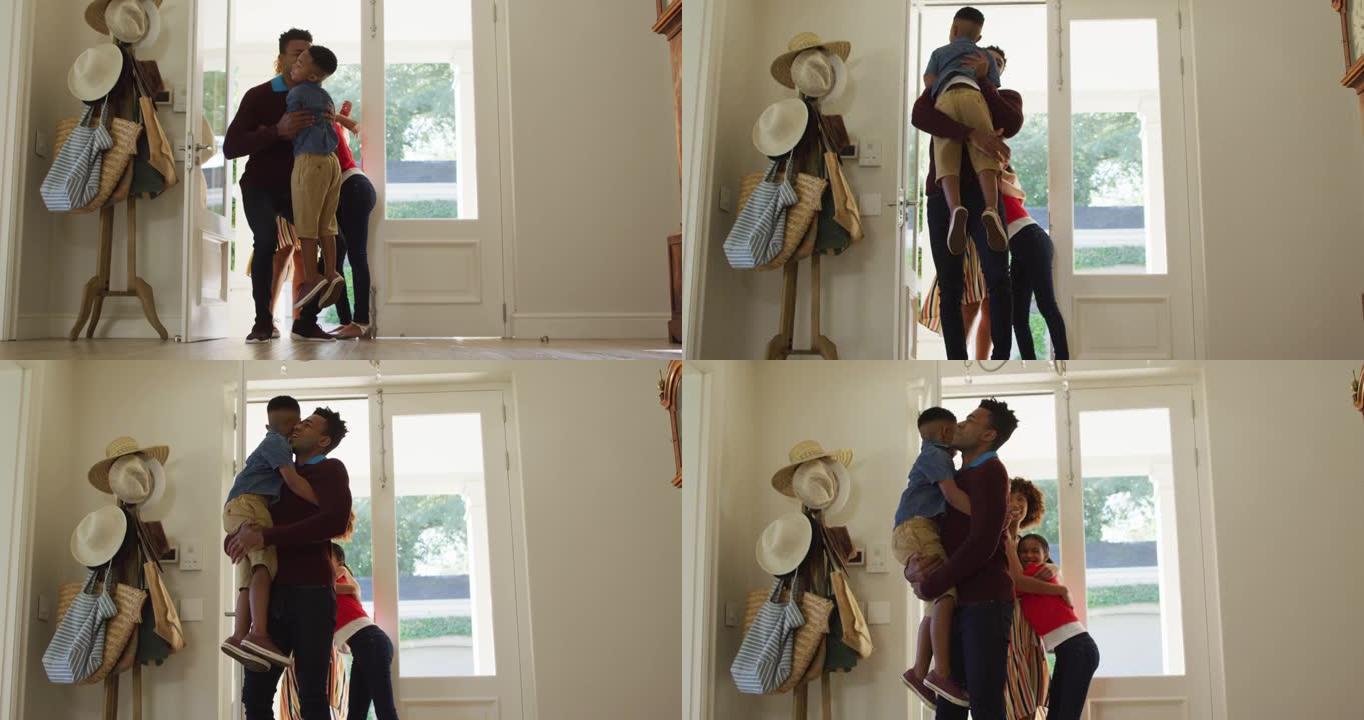 快乐的非裔美国人家庭从前门进入房屋