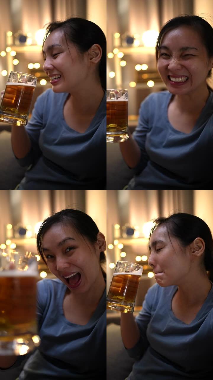 亚洲女性在视频电话会议上与朋友进行欢乐时光，手里拿着啤酒，垂直