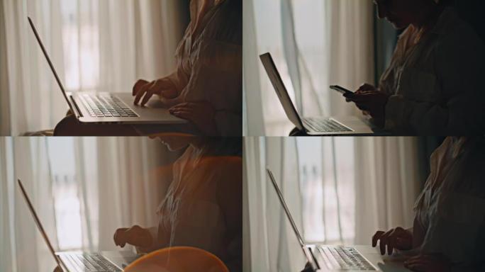 特写女人使用她的智能手机和笔记本电脑，坐在酒店房间的床上，背景是窗户和窗帘，慢动作