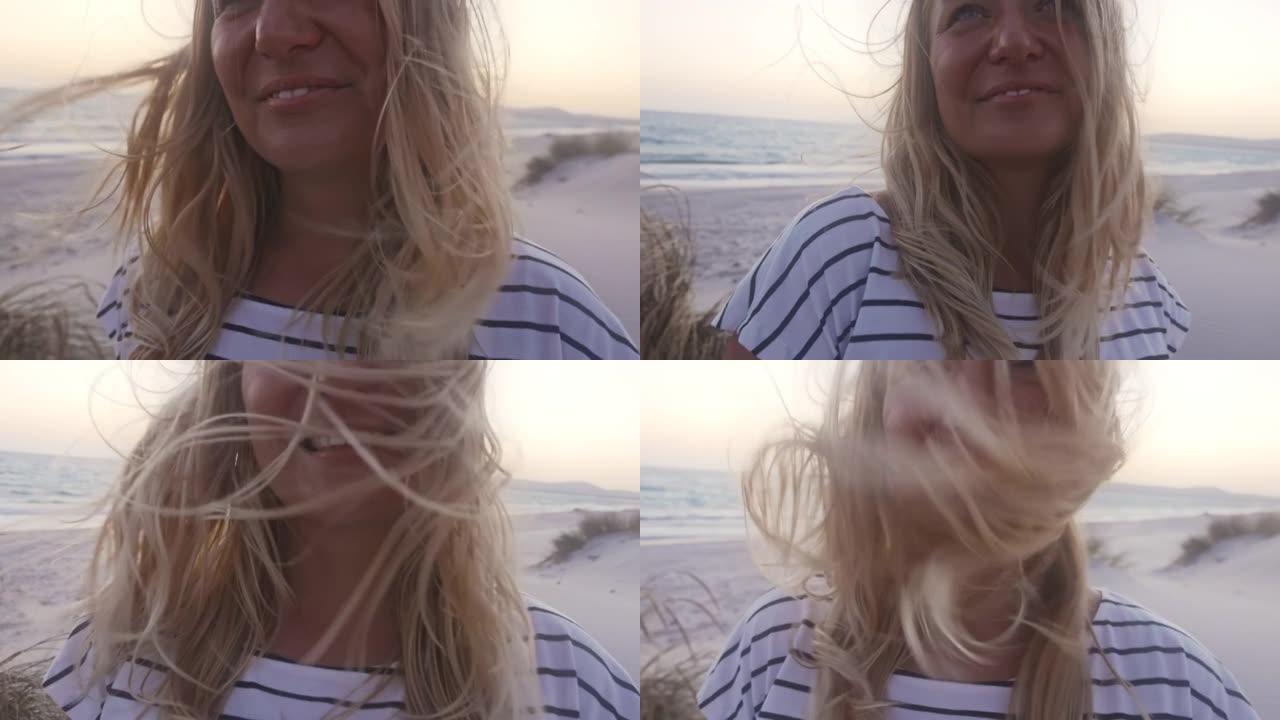 撒丁岛海滩上微笑的金发女孩的慢动作视图。
