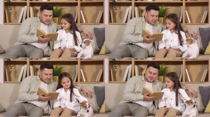 爸爸和小女儿和狗坐在沙发上看书