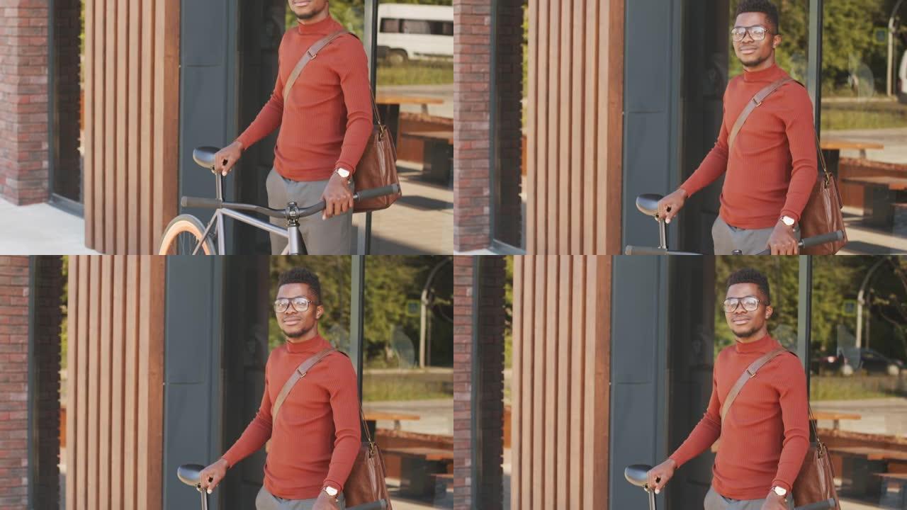 在市中心骑自行车的年轻非裔美国人的肖像