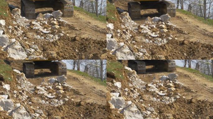 特写: 挖掘机操作员在漫长的一天工作后沿着泥土小径行驶。