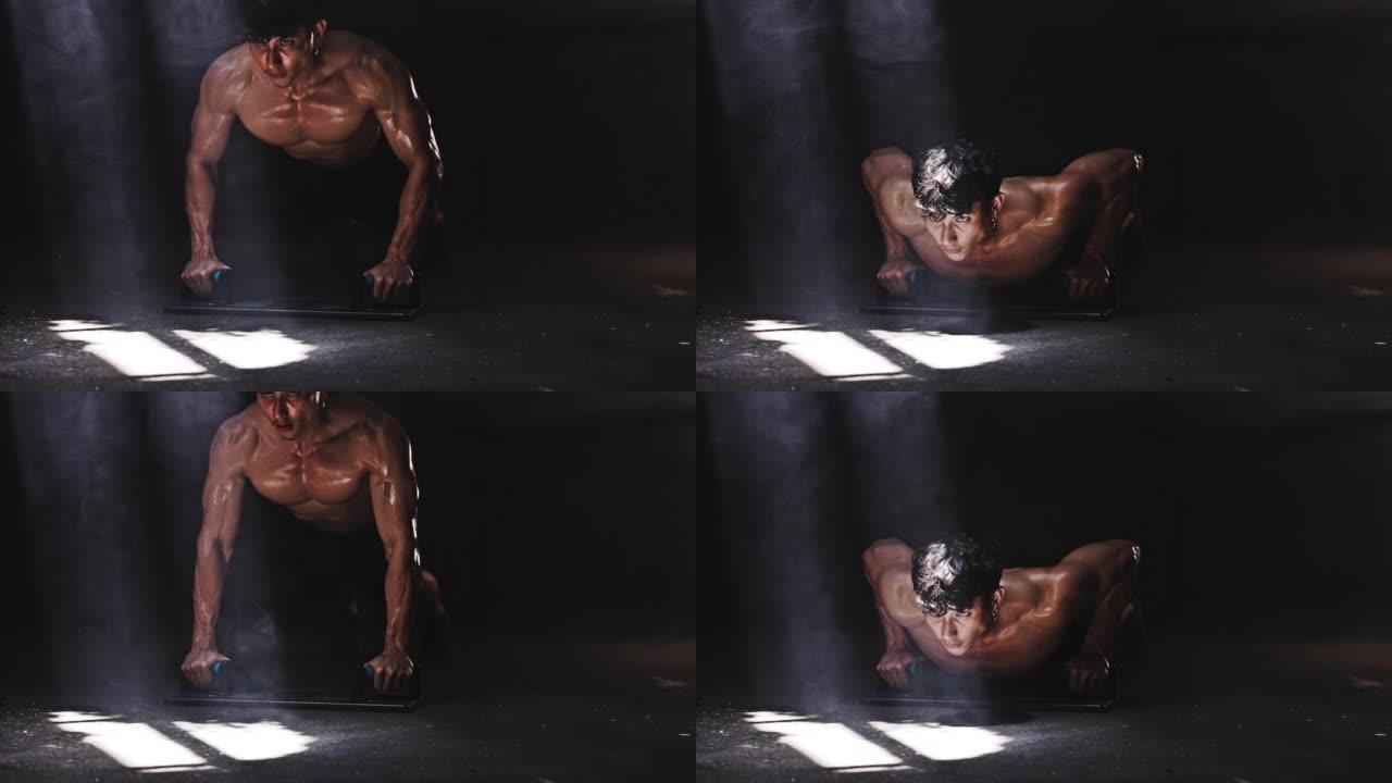 健康的亚洲运动男子运动员在废弃的黑暗健身房锻炼俯卧撑运动