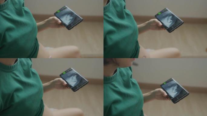 孕妇用手机看超声波结果的特写。