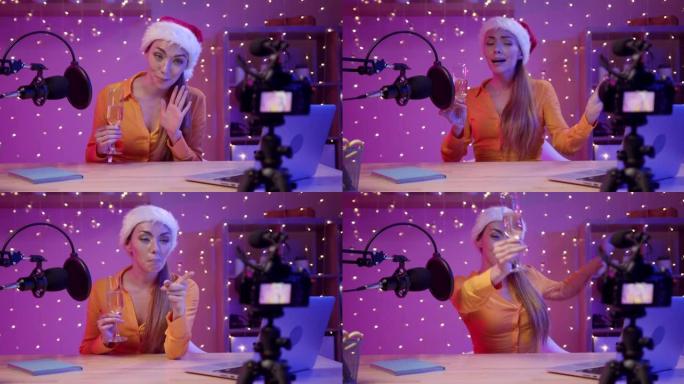 一个戴着圣诞老人帽子的博主女孩为她的订阅者录制了圣诞节视频问候