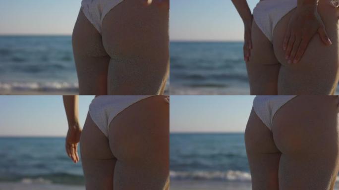 海滩上女人背的慢动作视图。