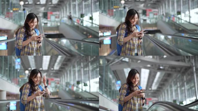 亚洲旅游妇女在机场自动扶梯上使用电话