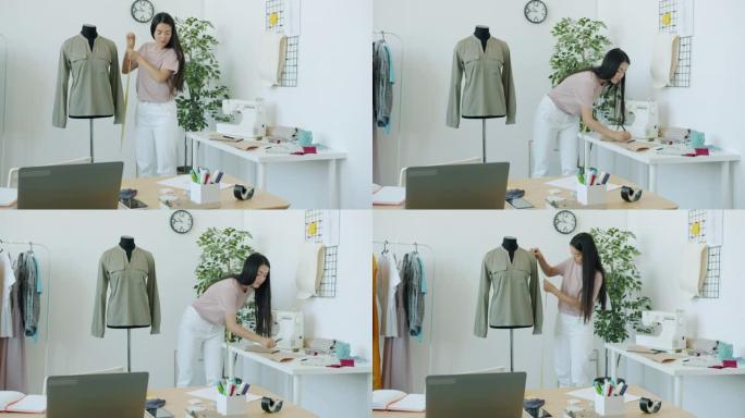 亚洲女裁缝的慢动作在裁缝的假人上测量服装，制作手工服装。