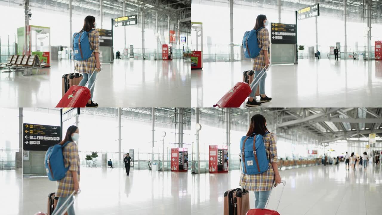 在航站楼机场的登机口散步的旅游妇女