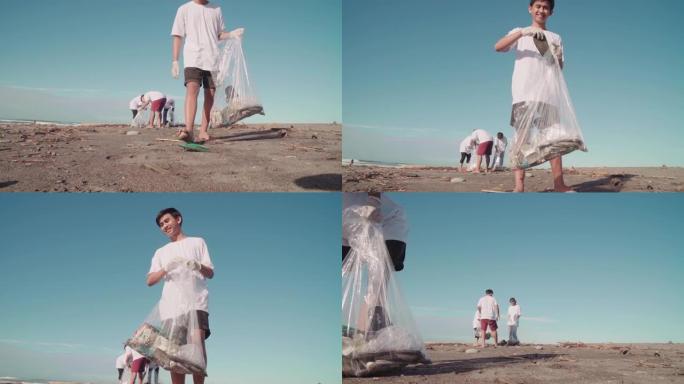 男孩在海岸线上收集垃圾