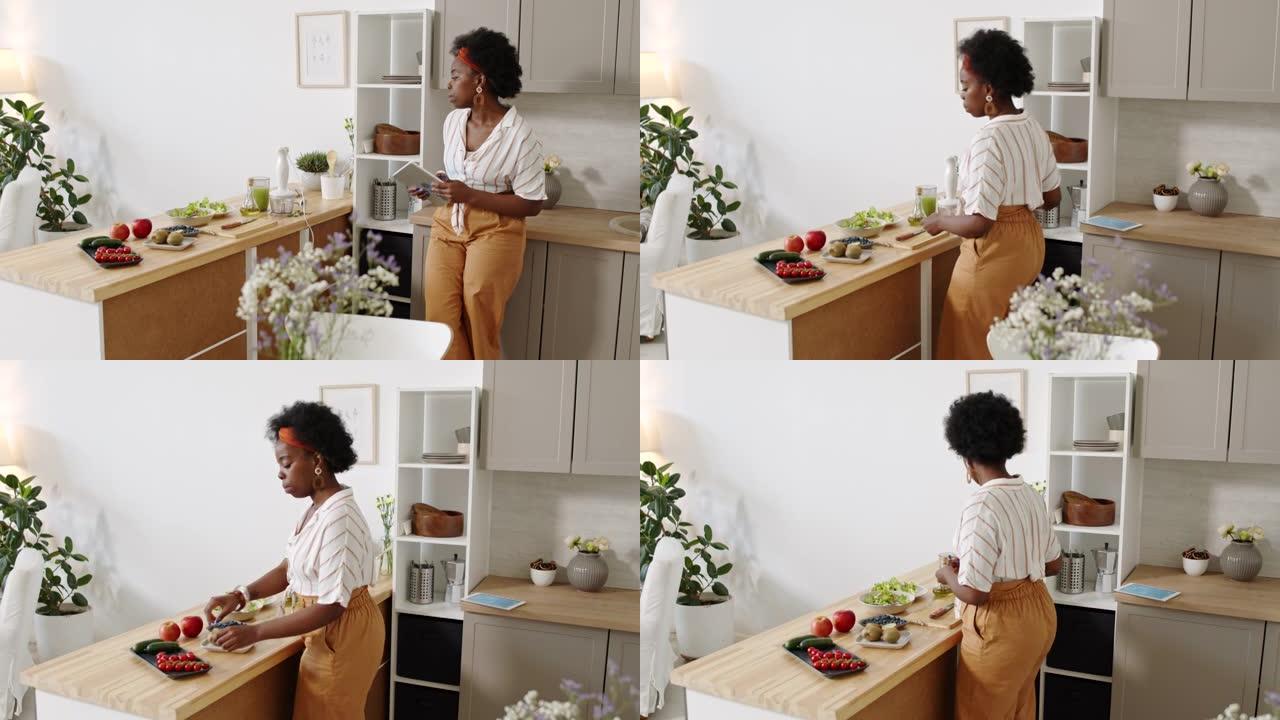 非裔美国妇女在数字平板电脑上通过食谱烹饪