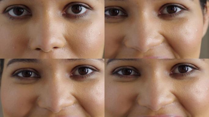 一个女人在验光师测试视力和视力的特写镜头。放大一个在验光预约期间微笑的女人，以检查她的眼睛并获得处方