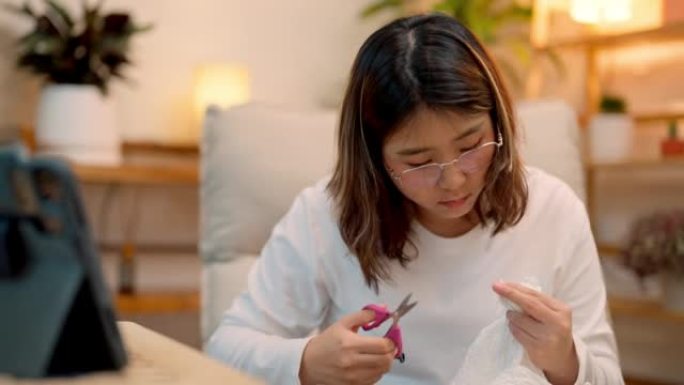 亚洲少女在家学习网上缝纫。