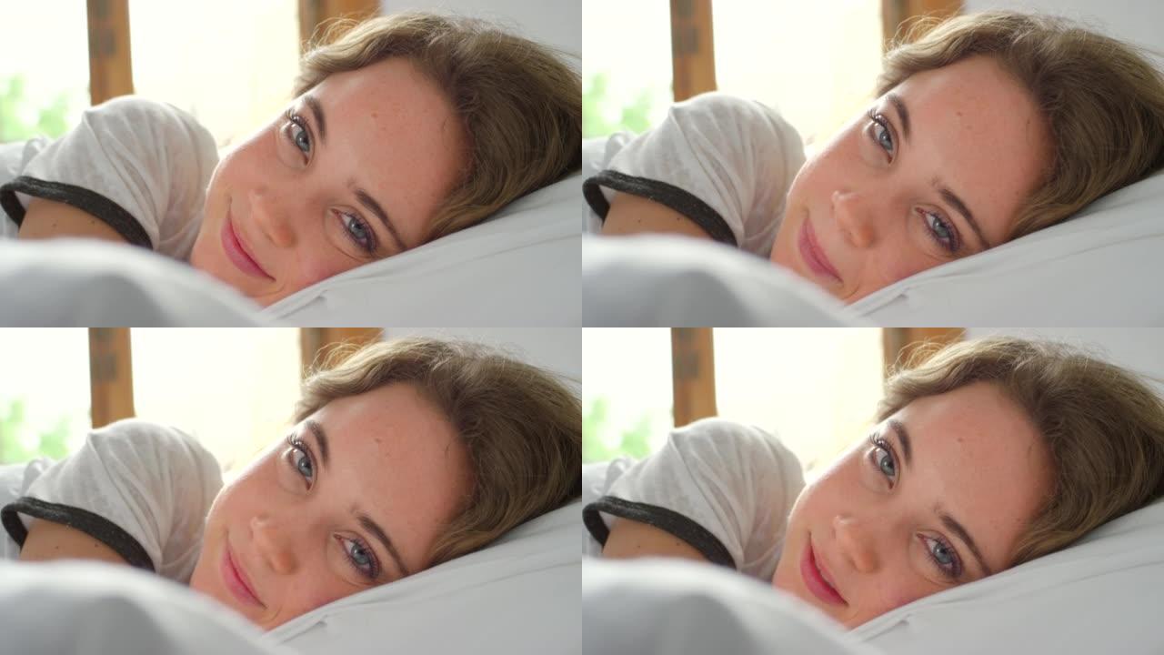 4k视频片段，一名年轻女子在床上放松