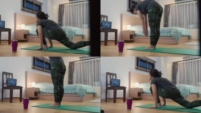 亚洲瑜伽教练训练学生在家卧室伸展运动
