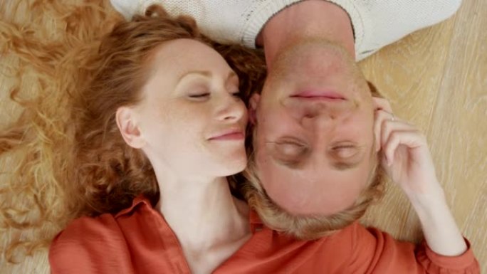 一对年轻夫妇躺在地板上共度时光的4k视频片段