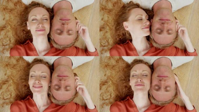 一对年轻夫妇躺在地板上共度时光的4k视频片段