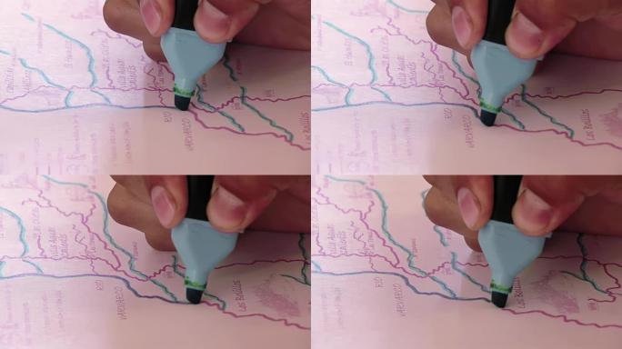 阿根廷小学生用荧光笔在内乌肯省的地图上工作。特写。4k分辨率。