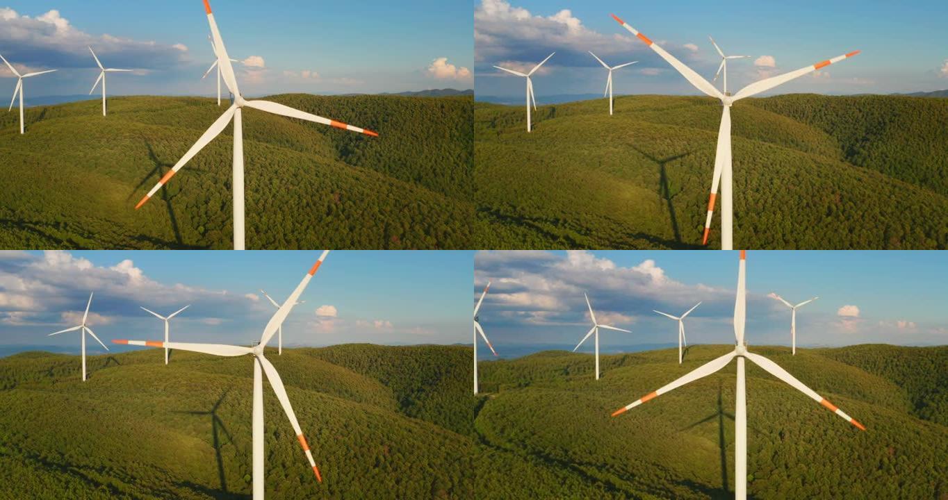 风车的空中特写镜头，风车在风的作用下旋转，并以绿色生态的方式向太阳照耀着地球产生可再生能源。