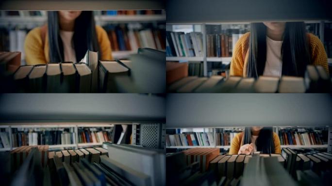 SLO MO年轻女子在图书馆的书架上寻找一本书