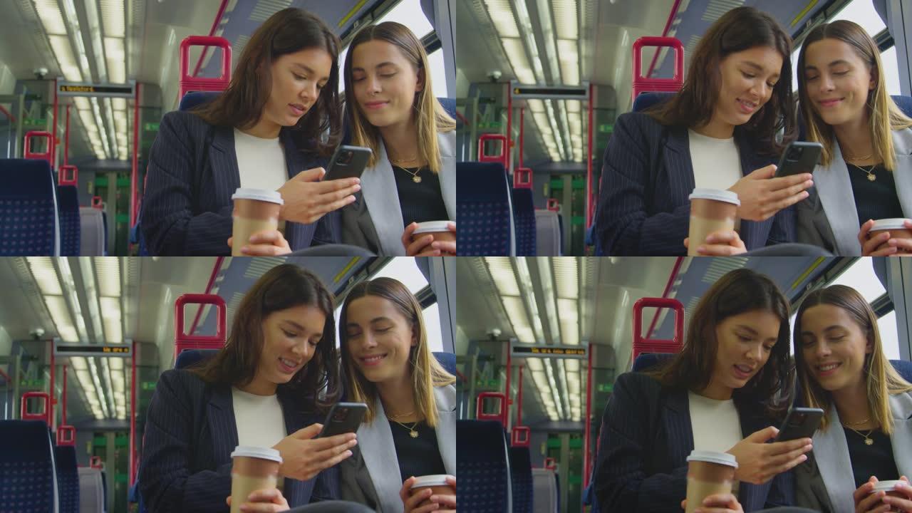 两名带外卖咖啡的女商人上下班在火车上一起看手机