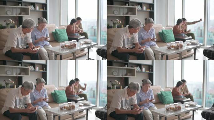老花眼的亚洲华裔老年夫妇在周末休闲时间难以在客厅学习使用智能手机