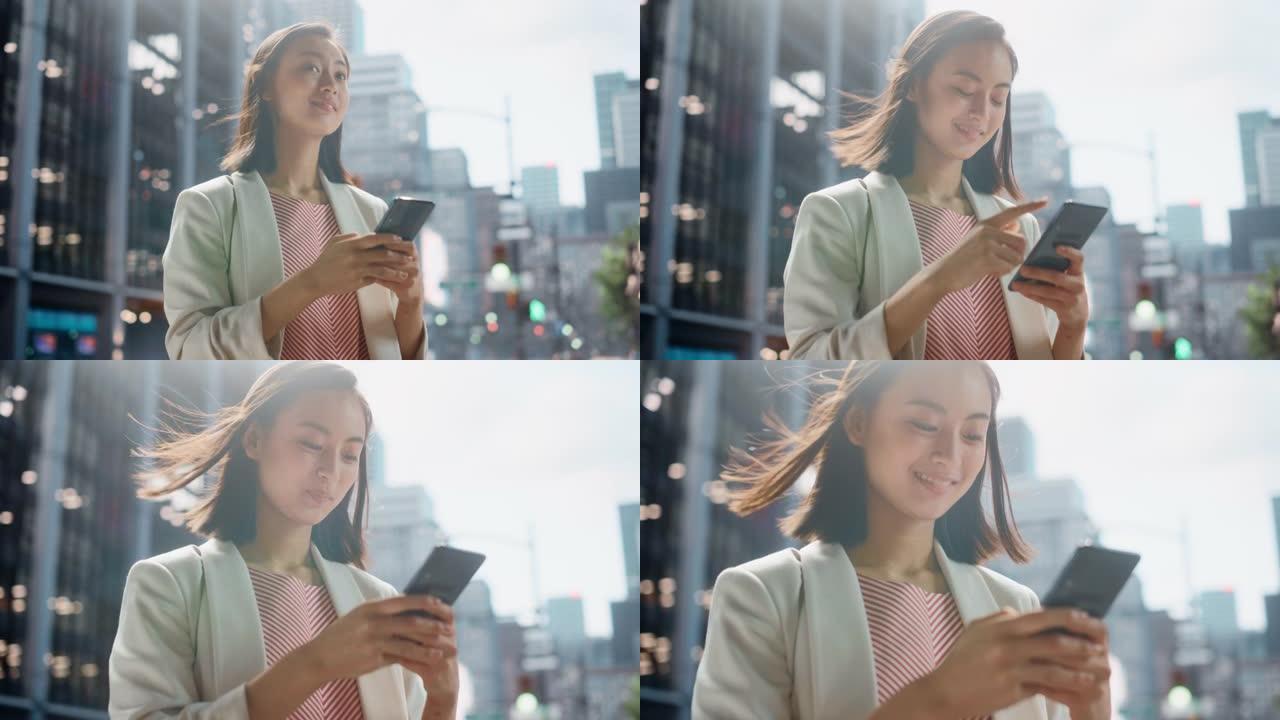 一位自信的日本女性穿着时髦的休闲服，在城市街道上使用智能手机的肖像。大城市的经理与人们在线联系，消息